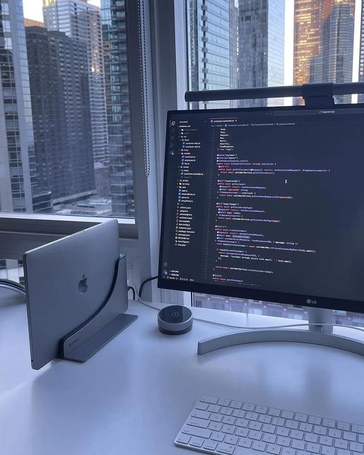  Desk setup featuring a computer monitor and laptop, representing Digitixel Marketing's expertise in web design and development.
